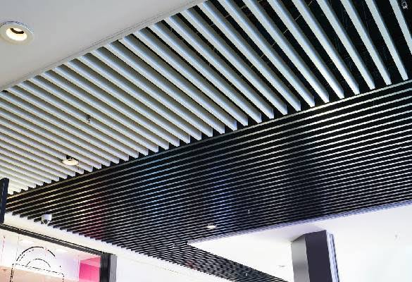 Contrasting white and dark baffle ceiling zones