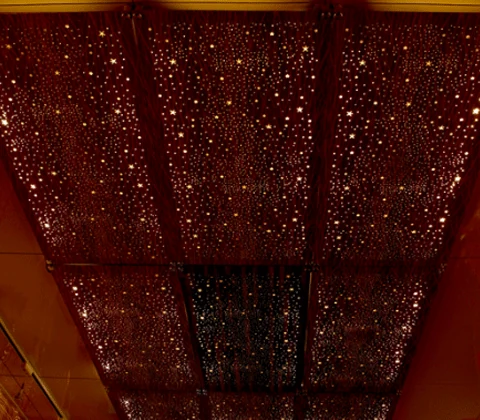 Warm illuminated perforated ceiling panels