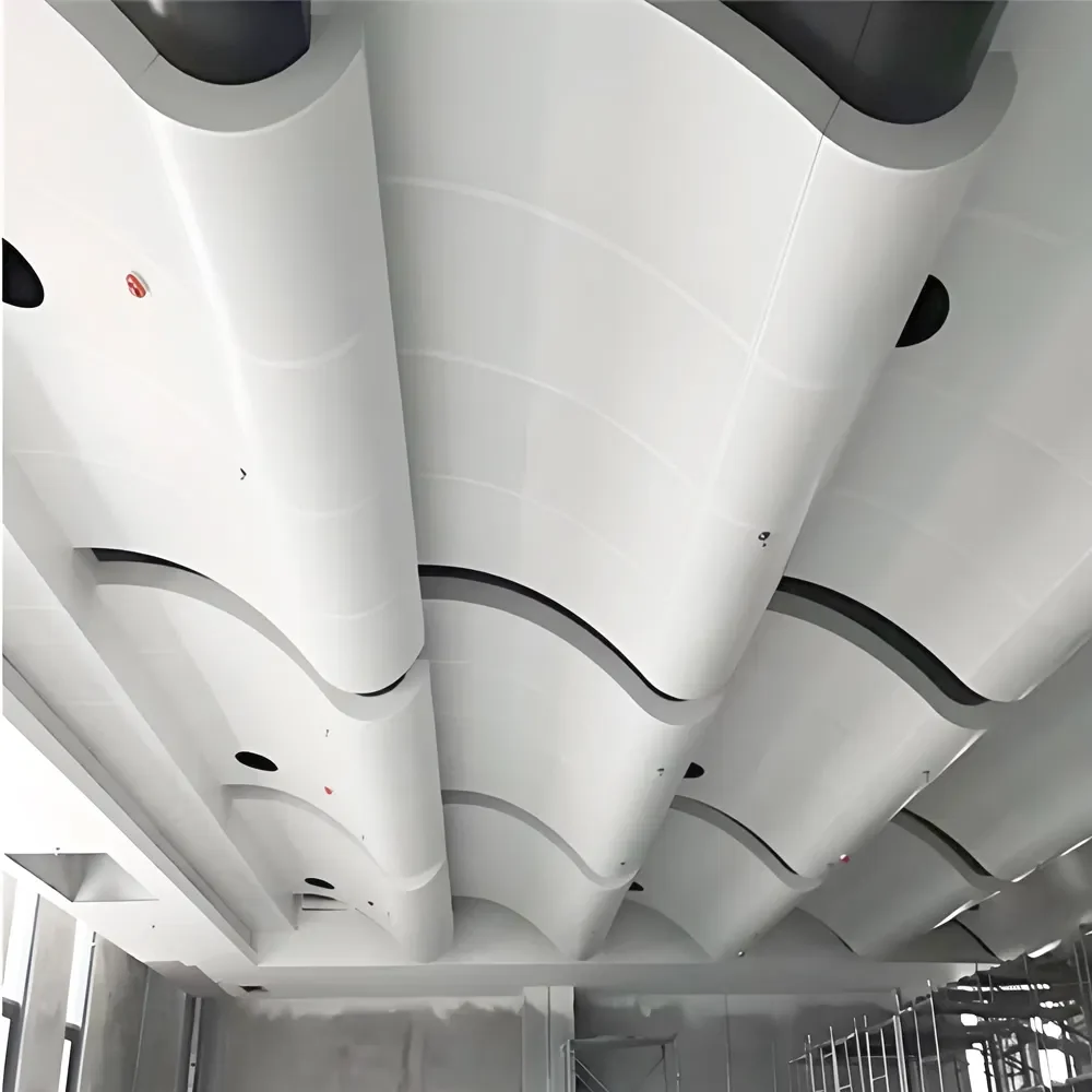 Curved perforated metal panels during interior fit-out