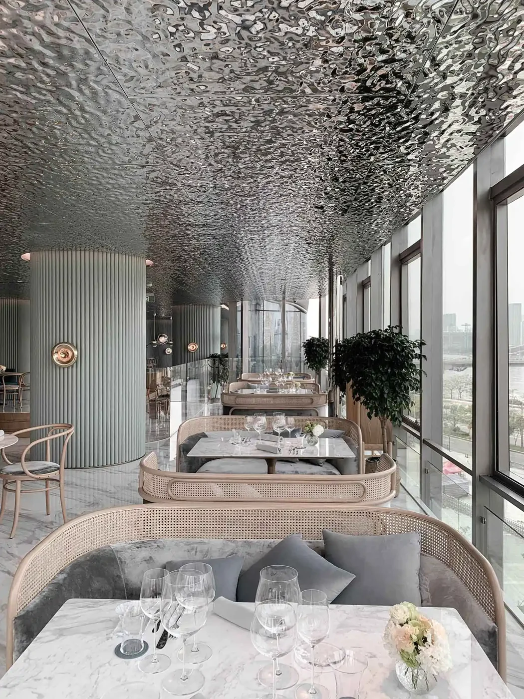 Reflective ripple ceiling in a contemporary dining interior