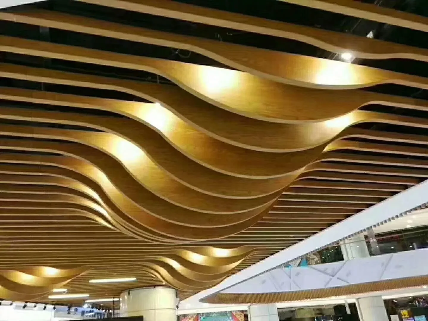 Wood-effect wave baffles in a commercial interior